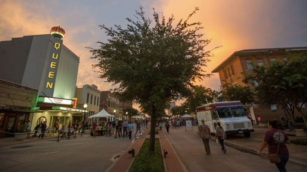 Street festival at sunset in Historic Downtown Bryan. Downtown Bryan Texas lofts and historic homes for sale